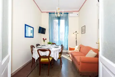 a dining room with a table and a couch at Boezio House in Rome
