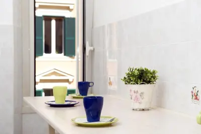 a table with plates and cups and a potted plant at Boezio House in Rome