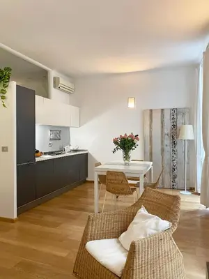 a kitchen and living room with a table and chairs at Via Giulia apartment / historic center of Rome in Rome