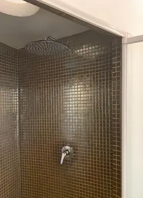 a shower with a shower head in a bathroom at Via Giulia apartment / historic center of Rome in Rome
