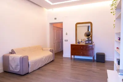 a bedroom with a bed and a dresser and a mirror at Regina Margherita Home in Rome