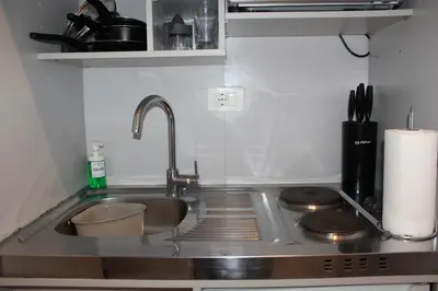 a kitchen counter with a sink and a stove at Argilla House 10 min a piedi dal Vaticano in Rome