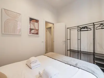 a white bedroom with a bed with towels on it at The Best Rent -Cozy two bedroom apartment near Vatican City in Rome