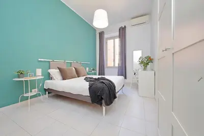 a bedroom with a bed and a blue wall at Casa Serafina in Prati district in Rome