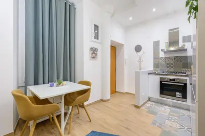 a kitchen and dining room with a table and chairs at Appartamento via Visconti in Rome