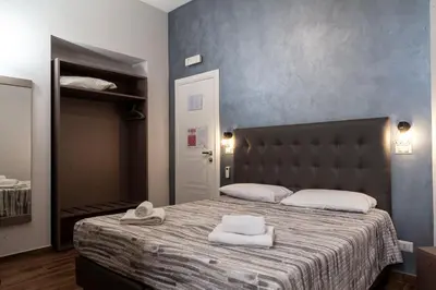 a bedroom with a bed with two towels on it at ANGI HOME in Rome
