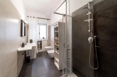 a bathroom with a shower and a toilet and a sink at EV Vatican Apartment in Rome