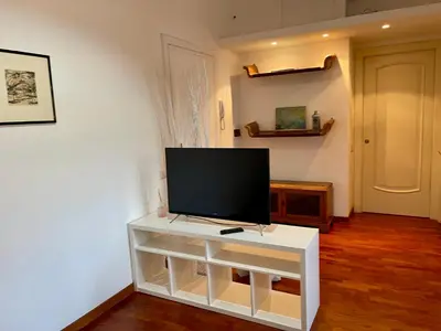 a flat screen tv on a white stand in a room at Edi's House in Rome