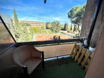 a balcony with a chair and a view of a basketball court at Edi's House in Rome