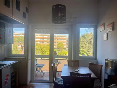 a dining room with a table and two windows at Edi's House in Rome