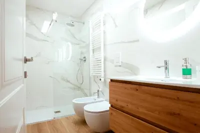 a white bathroom with a toilet and a sink at Dolce casa al Vaticano in Rome