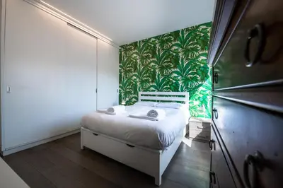 a bedroom with a bed and a green wall at Time 4 Rome in Rome