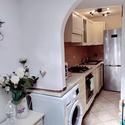 a kitchen with a refrigerator and a dishwasher at Appartamento Eleonora in Rome