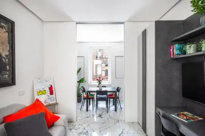 a living room with a table and a dining room at Romantic Suite Colosseum - Luxury Apartment in Rome
