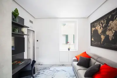 a living room with a gray couch and red pillows at Romantic Suite Colosseum - Luxury Apartment in Rome