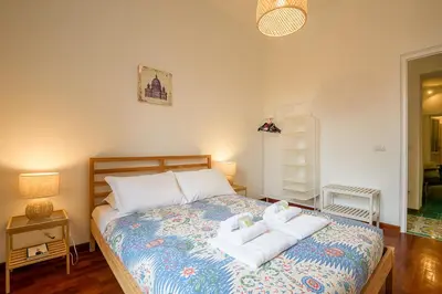 a bedroom with a bed with two towels on it at Candia Cento Apartment Vatican Museums in Rome