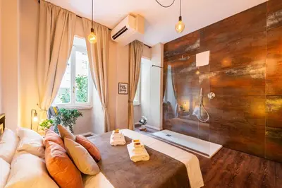 a room with a bed and a large wooden wall at Piacentino Homes Re di Roma apartment in Rome
