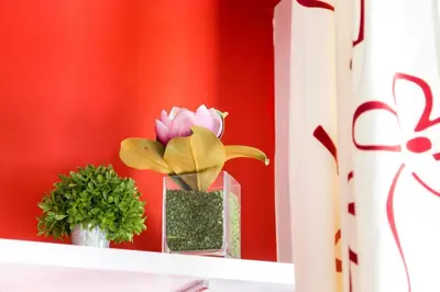 a shelf with two vases with flowers on it at Perla - Cozy Apartment in Piazza Navona in Rome