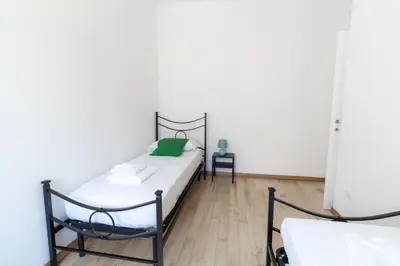a bedroom with a bed and a chair at Trastevere four seasons Feltre in Rome