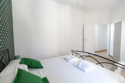 a bedroom with two beds with green pillows at Trastevere four seasons Feltre in Rome
