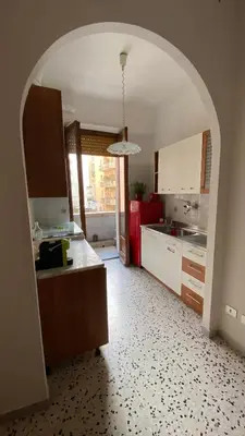 a kitchen with an archway in the middle of a room at MM Ma Maison in Rome