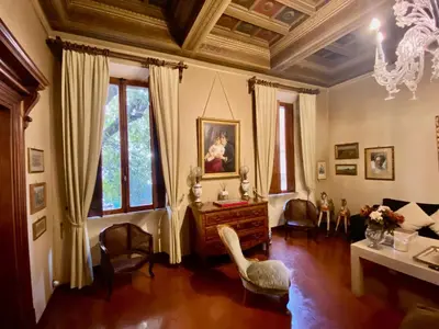 a living room with a table and chairs and a chandelier at 78 Luxury Margutta Suite in Rome