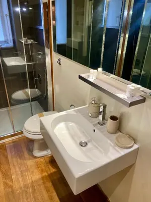 a bathroom with a white sink and a toilet at 78 Luxury Margutta Suite in Rome