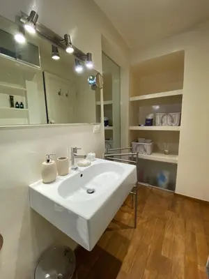 a bathroom with a white sink and a mirror at 78 Luxury Margutta Suite in Rome