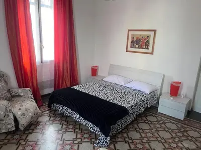 a bedroom with a bed and a chair in it at Ranieri casa vacanze in Rome