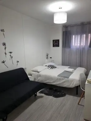 a white bedroom with two beds and a window at Domus Euclide in Rome