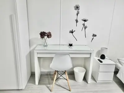 a white desk with a white chair and flowers at Domus Euclide in Rome