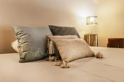 a bed with three pillows on top of it at Videnda Colosseo in Rome