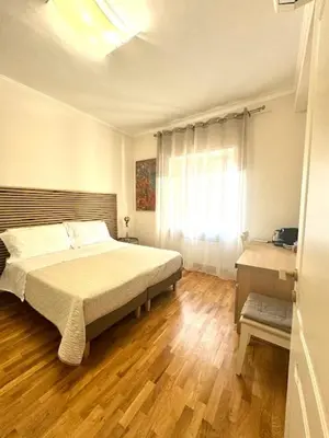 a bedroom with a large bed and a window at ARCA LUXURY HOME in Rome