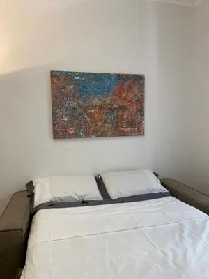 a bed in a room with a painting on the wall at ARCA LUXURY HOME in Rome
