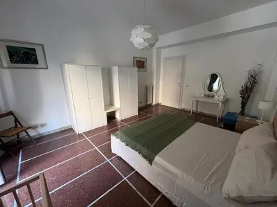 a bedroom with a bed and a table and a chair at Dolce Vita Suites in Rome