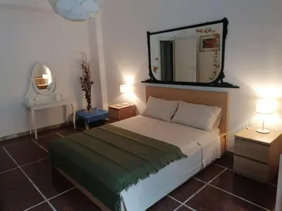 a bedroom with a bed with a mirror on the wall at Dolce Vita Suites in Rome