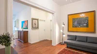 a living room with a couch and a painting on the wall at EasyTopStay - Crescenzio Elegant Apartment in Rome