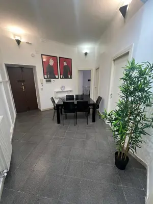 a dining room with a table and a potted plant at Nic trastevere house in Rome