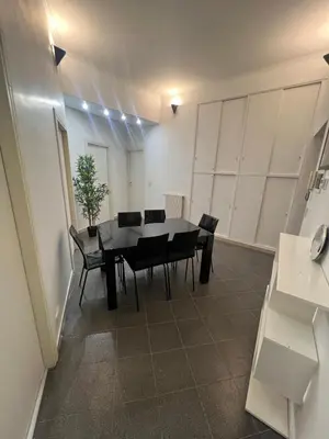 a dining room with a table and chairs at Nic trastevere house in Rome