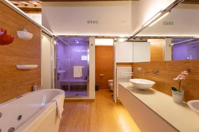 a bathroom with a large tub and a sink at Restart Accommodations Moro in Rome