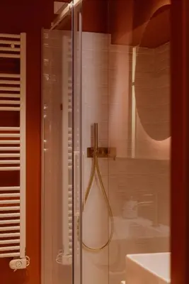 a shower in a bathroom with a glass door at Restart Accommodations Tritone in Rome