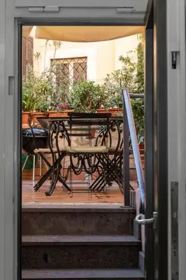 an open door to a patio with a table and chairs at Restart Accommodations Nettuno in Rome