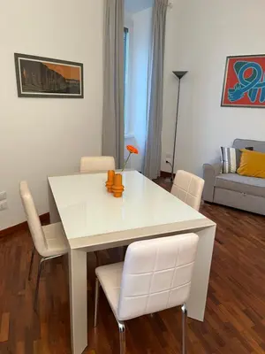 a white table and chairs in a living room at La casa di Monica appartamento Ostiense Roma in Rome
