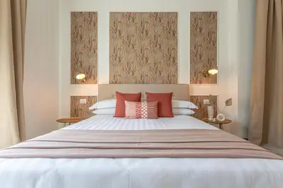 a bedroom with a large bed with red pillows at Cornelia cozy home in Rome