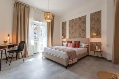 a bedroom with a bed and a table and a desk at Cornelia cozy home in Rome