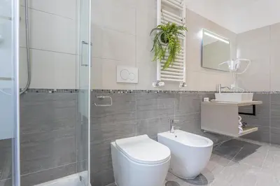 a bathroom with a toilet and a sink and a shower at Cornelia cozy home in Rome