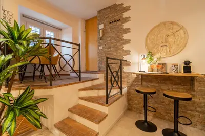 a staircase in a living room with stools at Pearl of Circo Massimo in Rome