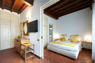 a bedroom with a large bed and a television at La Perla di Trevi in Rome