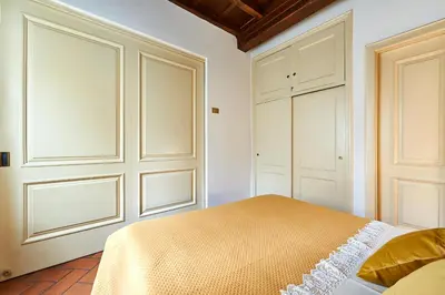 a bedroom with a bed and two white cabinets at La Perla di Trevi in Rome