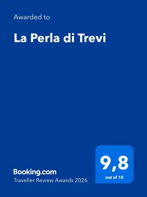 a screenshot of a cell phone with the text awarded to la perla del text at La Perla di Trevi in Rome